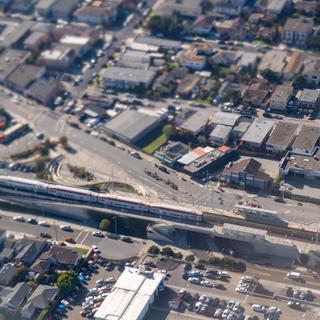 San Bruno caltrain station taken while landing at SFO; the distortion caused by the window and engine exhaust happens to create a tilt shift-like effect.