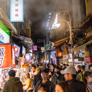 Shilin night market in Taipei with steam coming from a stall.